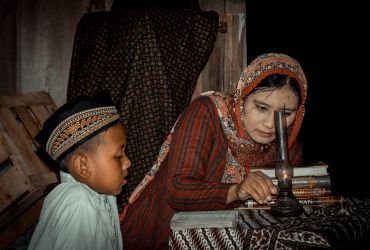 Woman teaching a young boy